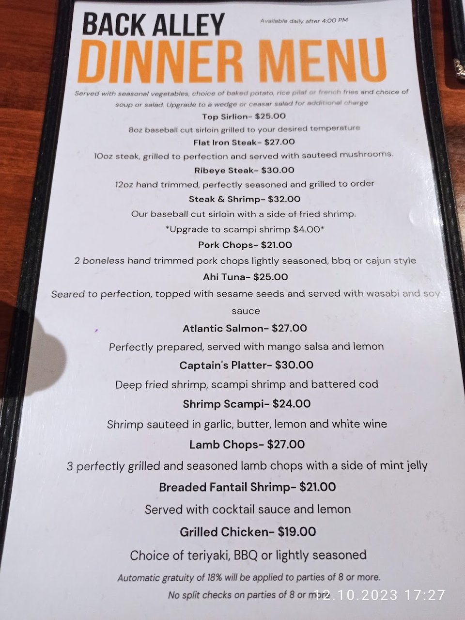 Menu board with burgers, steaks, and seafood.