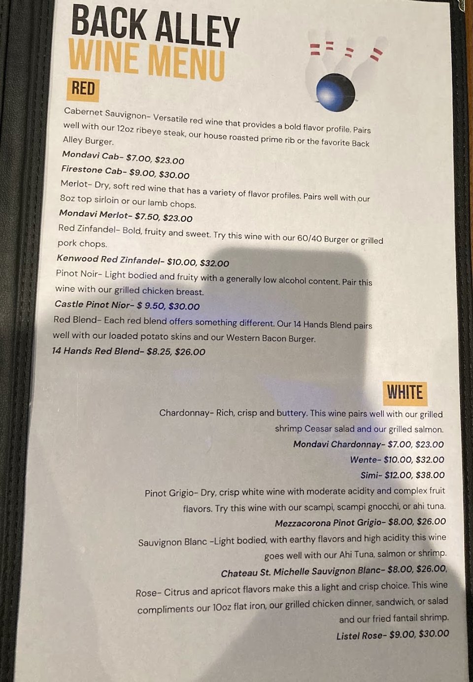 Printed menu beside the restaurant counter.